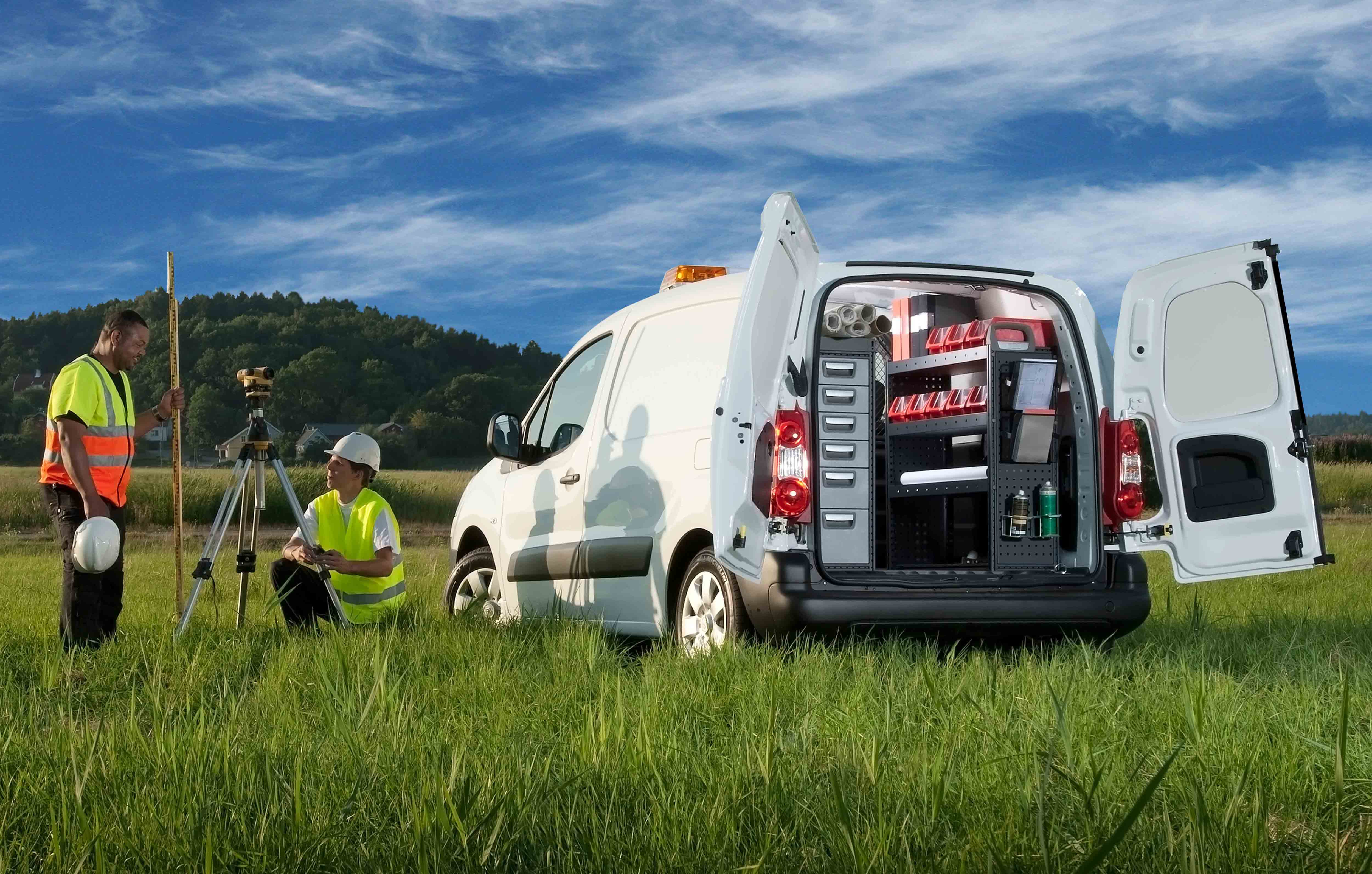 Worker's van fitted out with modul-system van racking in a field